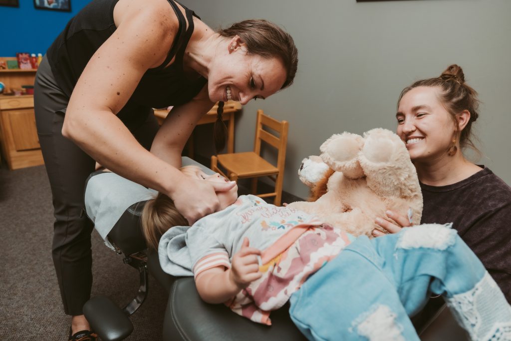 Smiling child at kids adjustment with Dr. Christie at Exuberance Chiropractic and Wellness in Lakeville MN.