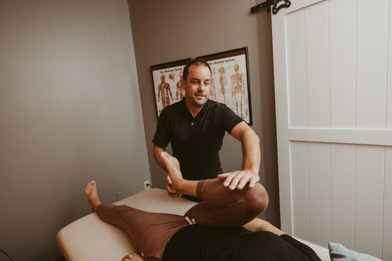 Chiropractor doing lower body leg adjustment at Exuberance Chiropractic and Wellness.